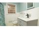 Cozy bathroom featuring a modern vanity, updated fixtures, and a tiled shower with patterned curtain at 98 Almon Church Rd, Covington, GA 30014