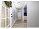 Inviting hallway featuring light blue walls, modern gray flooring, and transom-windowed door at 98 Almon Church Rd, Covington, GA 30014