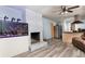 Open-concept living room with a painted fireplace, saltwater aquarium, and modern wood-look flooring at 98 Almon Church Rd, Covington, GA 30014