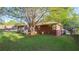 Back of home featuring a screened in porch and a lush lawn for outdoor living and relaxation at 2685 Buena Vista Ave, Doraville, GA 30340