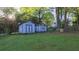 View of two backyard storage sheds with blue trim in a well-maintained yard with mature trees at 2685 Buena Vista Ave, Doraville, GA 30340