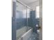 Neat bathroom with blue tile, tub, and natural light at 2685 Buena Vista Ave, Doraville, GA 30340