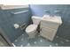 Bathroom features light-blue tile, toilet, and sink with white mosaic tile floor at 2685 Buena Vista Ave, Doraville, GA 30340