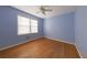 Bedroom featuring hardwood floors, blue walls, and a window allowing natural light at 2685 Buena Vista Ave, Doraville, GA 30340