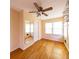 Bedroom with hardwood floors, ceiling fan, and natural light from the windows at 2685 Buena Vista Ave, Doraville, GA 30340