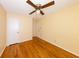 Bedroom features hardwood floors, yellow walls, a ceiling fan, and two white doors at 2685 Buena Vista Ave, Doraville, GA 30340