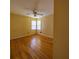 Bedroom showcasing hardwood floors, yellow walls, and a ceiling fan with lighting at 2685 Buena Vista Ave, Doraville, GA 30340