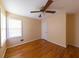 Bedroom with hardwood floors, ceiling fan, and natural light from windows at 2685 Buena Vista Ave, Doraville, GA 30340