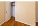 Bedroom featuring hardwood floors, yellow walls, and closet with open door to reveal storage at 2685 Buena Vista Ave, Doraville, GA 30340