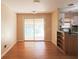 Dining area with hardwood floors, sliding glass door, and view into kitchen at 2685 Buena Vista Ave, Doraville, GA 30340