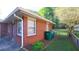 Brick home featuring a gated backyard and a small lawn at 2685 Buena Vista Ave, Doraville, GA 30340