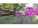 Landscaped front yard with mature trees and vibrant azaleas adding curb appeal to the home at 2685 Buena Vista Ave, Doraville, GA 30340