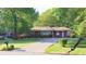 Charming brick home features a well-manicured lawn and a long driveway leading to the entrance at 2685 Buena Vista Ave, Doraville, GA 30340