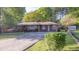 Charming brick ranch home featuring a long driveway and well-maintained landscaping at 2685 Buena Vista Ave, Doraville, GA 30340