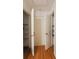 Hallway with access to closets, hardwood floors, neutral paint at 2685 Buena Vista Ave, Doraville, GA 30340