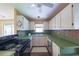 Galley-style kitchen featuring white cabinets, and green countertops at 2685 Buena Vista Ave, Doraville, GA 30340
