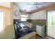 Galley-style kitchen featuring white cabinets, black appliances, and green countertops at 2685 Buena Vista Ave, Doraville, GA 30340