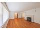 Spacious living room with hardwood floors, a fireplace, and ample natural light at 2685 Buena Vista Ave, Doraville, GA 30340