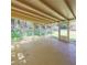 Open sunroom with concrete floors, beams, and views of the backyard at 2685 Buena Vista Ave, Doraville, GA 30340