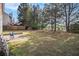 Large backyard with mature trees and a small patio area at 3243 Timber Rdg, College Park, GA 30349