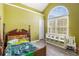 Bedroom with vaulted ceilings and large arch window and hardwood floors at 3243 Timber Rdg, College Park, GA 30349