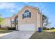 Two story home with an attached two car garage and manicured lawn at 3243 Timber Rdg, College Park, GA 30349