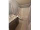 Clean bathroom featuring a dark vanity and a shower-tub combo at 3371 Metro Way, Snellville, GA 30039