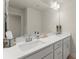 Bathroom featuring double sinks, a large mirror, and modern fixtures for a stylish and functional space at 350 Hayden Cir, Woodstock, GA 30189