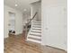 Welcoming entryway featuring hardwood floors, a staircase with a wooden handrail, and a convenient mudroom area at 350 Hayden Cir, Woodstock, GA 30189