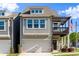 Charming two-story home featuring a front-facing garage, a quaint second-story balcony, and an American flag at 350 Hayden Cir, Woodstock, GA 30189