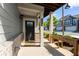 Inviting front porch with gray siding, a dark front door, a hanging lantern, and charming planter boxes at 350 Hayden Cir, Woodstock, GA 30189