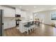 Bright kitchen features white cabinets, stainless steel appliances, a central island with bar seating, and hardwood floors at 350 Hayden Cir, Woodstock, GA 30189