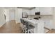 Bright kitchen features white cabinets, stainless steel appliances, a central island with bar seating, and hardwood floors at 350 Hayden Cir, Woodstock, GA 30189