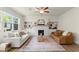 Bright living room featuring fireplace, built-in bookshelves and large windows at 350 Hayden Cir, Woodstock, GA 30189