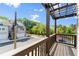 View from covered patio looking out over front yard, street, and neighboring homes on a bright day at 350 Hayden Cir, Woodstock, GA 30189