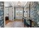 Elegant foyer with patterned wallpaper, light hardwood floors, and a stylish console table at 5255 Heirloom Overlook, Cumming, GA 30040