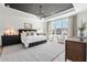 Spacious main bedroom with large windows, sitting area, and stylish decor at 5255 Heirloom Overlook, Cumming, GA 30040