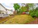 Landscaped backyard with lawn, stone accents, and bordered by trees providing privacy at 914 Denmeade Sw Walk, Marietta, GA 30064