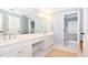 This bright bathroom is adorned with a double vanity and is enhanced by classic white cabinets and a neutral rug at 914 Denmeade Sw Walk, Marietta, GA 30064