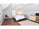 This charming bedroom features a wooden floor and a sloped roof with a cozy place to relax at 914 Denmeade Sw Walk, Marietta, GA 30064