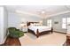 A spacious bedroom features a wooden bed frame, ceiling fan and two windows offering natural light at 914 Denmeade Sw Walk, Marietta, GA 30064
