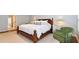 A charming bedroom features a wooden bed frame, complemented by green patterned pillows and an inviting green armchair at 914 Denmeade Sw Walk, Marietta, GA 30064
