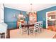 Elegant dining room featuring dark blue walls and a modern chandelier at 914 Denmeade Sw Walk, Marietta, GA 30064