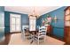 Stylish dining room with dark blue walls and a chandelier over a large table at 914 Denmeade Sw Walk, Marietta, GA 30064