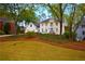 Charming white brick home with a well-manicured lawn and mature trees at 914 Denmeade Sw Walk, Marietta, GA 30064