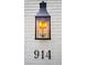 Close-up of a gas lantern, house number 914, on a white brick wall at 914 Denmeade Sw Walk, Marietta, GA 30064