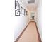 An inviting hallway, adorned with framed pictures and hardwood floors leads to a well lit open room at 914 Denmeade Sw Walk, Marietta, GA 30064