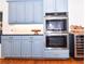 Close up of kitchen with modern appliances and blue cabinetry at 914 Denmeade Sw Walk, Marietta, GA 30064