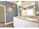 Bathroom with double sink vanity with granite countertop and large mirror providing a luxurious experience at 191 Fairview Oak Trl, Dallas, GA 30157