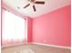 Bright bedroom featuring a ceiling fan, carpeted floor, and pink walls providing a cozy atmosphere at 191 Fairview Oak Trl, Dallas, GA 30157